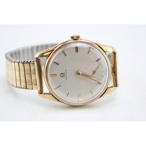 30 - A gentleman's 9ct gold cased, vintage Omega watch, the signed champagne dial with baton numerals, mi... 
