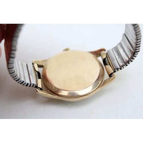 30 - A gentleman's 9ct gold cased, vintage Omega watch, the signed champagne dial with baton numerals, mi... 