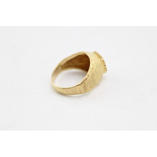 338 - A gold ring, of curved textured pyramidal form, set with square panel of nine small cubic zirconia, ... 