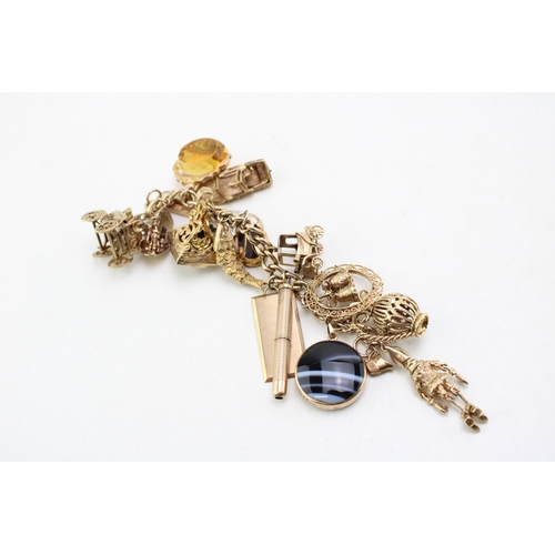 340 - A 9ct curb link gold charm bracelet, having rectangular padlock clasp and with fourteen oversized 9c... 