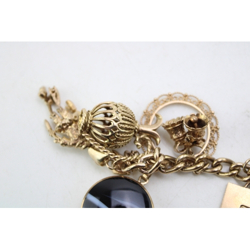 340 - A 9ct curb link gold charm bracelet, having rectangular padlock clasp and with fourteen oversized 9c... 