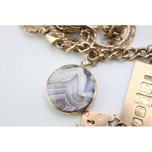 340 - A 9ct curb link gold charm bracelet, having rectangular padlock clasp and with fourteen oversized 9c... 