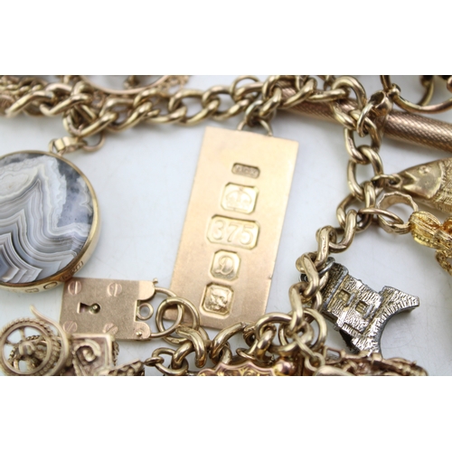 340 - A 9ct curb link gold charm bracelet, having rectangular padlock clasp and with fourteen oversized 9c... 