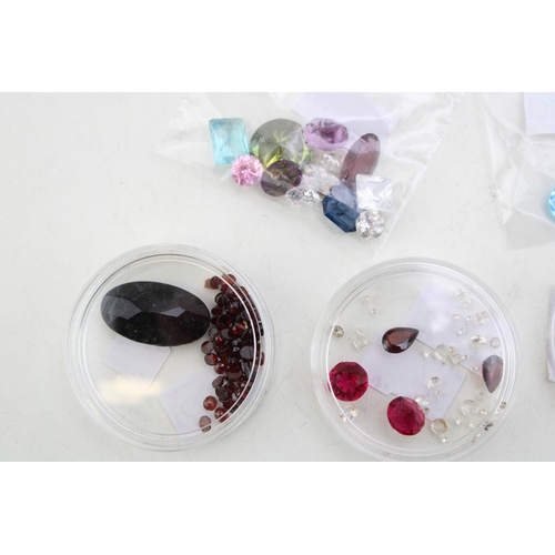 341 - A group of vintage loose gemstones, including garnets, tourmaline, heart cut amethyst, topaz, agate ... 