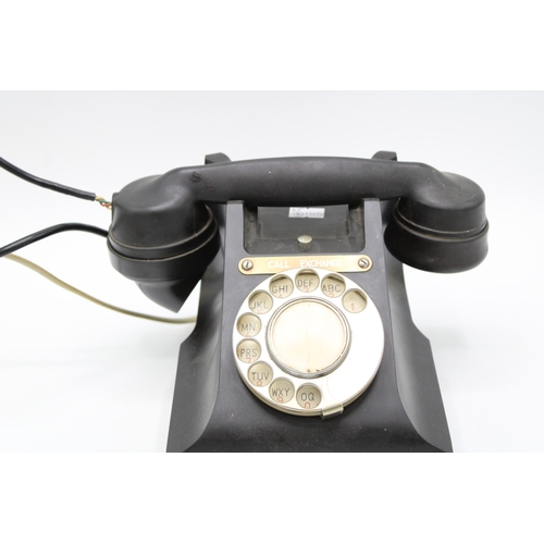 274 - G.P.O. bakelite telephone, E2 6295, 'Call Exchange' plate, 15cm tall.