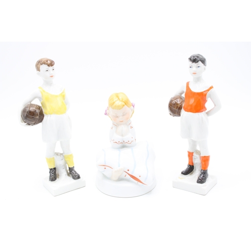 90 - A pair of USSR footballing figures with a Royal Dux figurine of a girl (3).