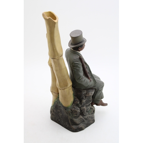174 - Johann Marsesch figure of a well dressed gentleman  sat upon a rock, 37cm tall, impressed marks to u... 