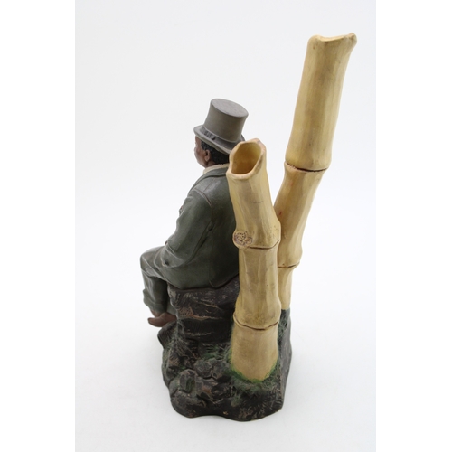 174 - Johann Marsesch figure of a well dressed gentleman  sat upon a rock, 37cm tall, impressed marks to u... 