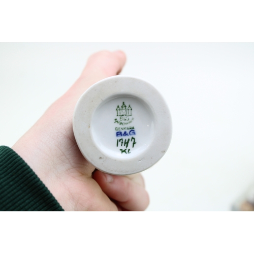 177 - A Royal Copenhagen figure of a farmer with scythe 685 with a B&G figure of a boy with a puppy (2).