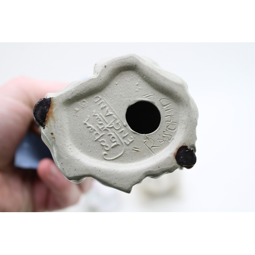 213 - A Janus pottery figure of a child with a cornucopia shell, a Royal Doulton bulldog and a Cooper Clay... 