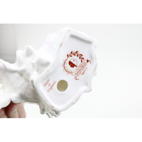 213 - A Janus pottery figure of a child with a cornucopia shell, a Royal Doulton bulldog and a Cooper Clay... 