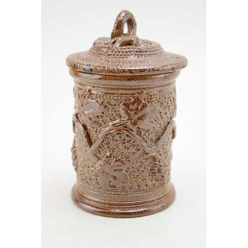 241 - A Victorian stoneware jar and cover, with ivy vine decoration, 13.5cm tall.