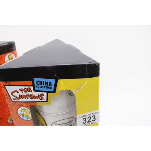 323 - Two boxed Coalport sets of The Simpsons stacking mugs (2 boxed sets of 4).