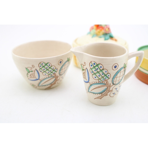 351 - Clarice Cliff to include a Celtic Harvest lidded jar, a Crocus base with a Wilkinson milk and sugar ... 