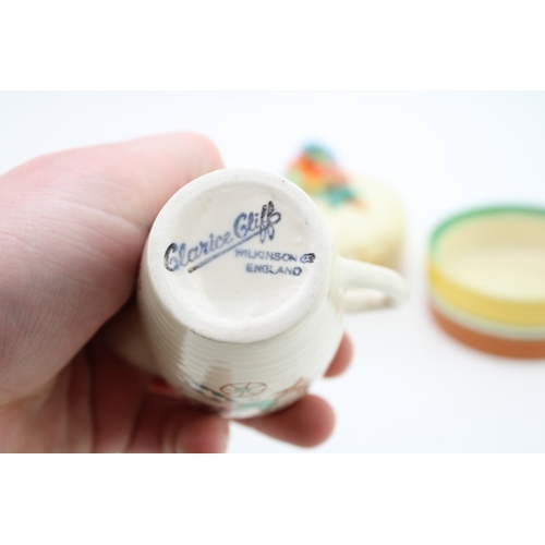 351 - Clarice Cliff to include a Celtic Harvest lidded jar, a Crocus base with a Wilkinson milk and sugar ... 