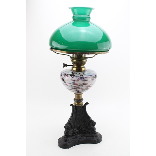 453 - Wizard oil lamp, made in Prussia, cast iron base, mottled glass bowl, green glass shade, 65cm tall.