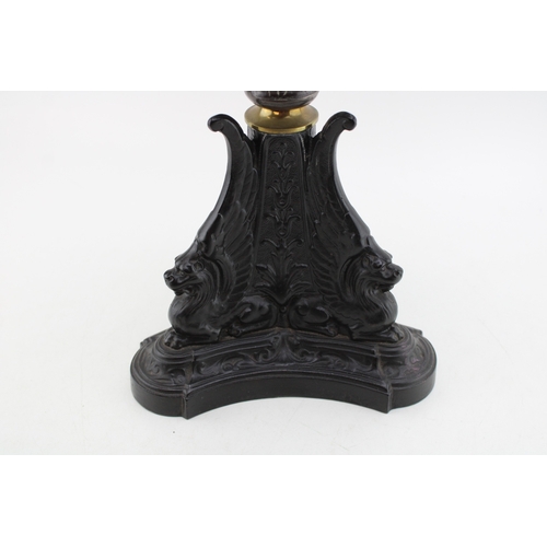 453 - Wizard oil lamp, made in Prussia, cast iron base, mottled glass bowl, green glass shade, 65cm tall.