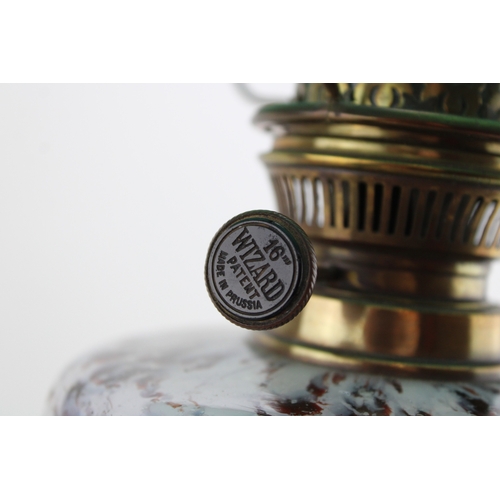 453 - Wizard oil lamp, made in Prussia, cast iron base, mottled glass bowl, green glass shade, 65cm tall.