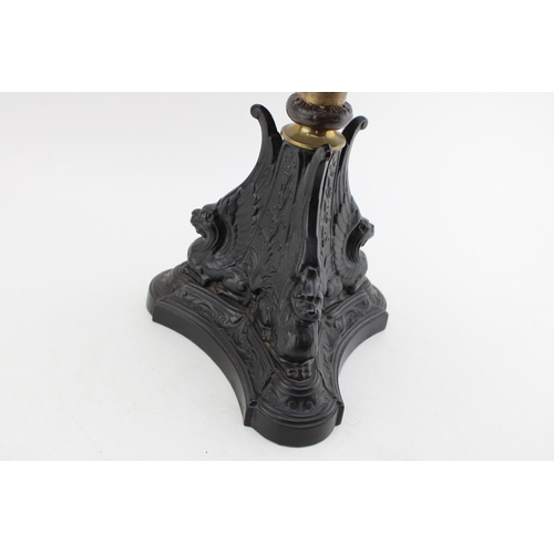 453 - Wizard oil lamp, made in Prussia, cast iron base, mottled glass bowl, green glass shade, 65cm tall.