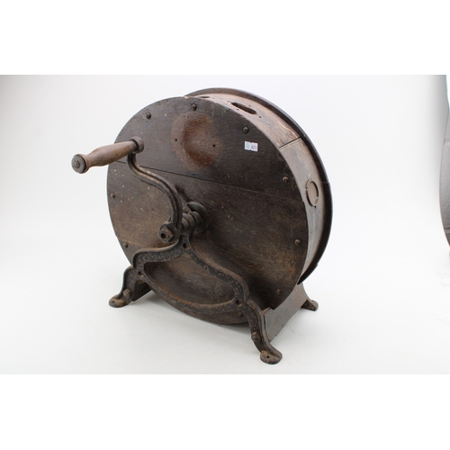 457 - A vintage knife sharpening tool on cast metal base, 40cm tall, 40cm wide.