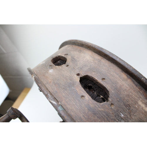 457 - A vintage knife sharpening tool on cast metal base, 40cm tall, 40cm wide.