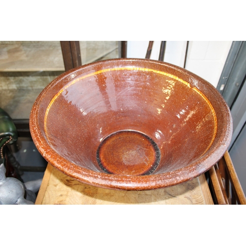 466 - An early 20th century farmhouse dairy bowl, also known as a pancheon or tian bowl, terracotta with g... 