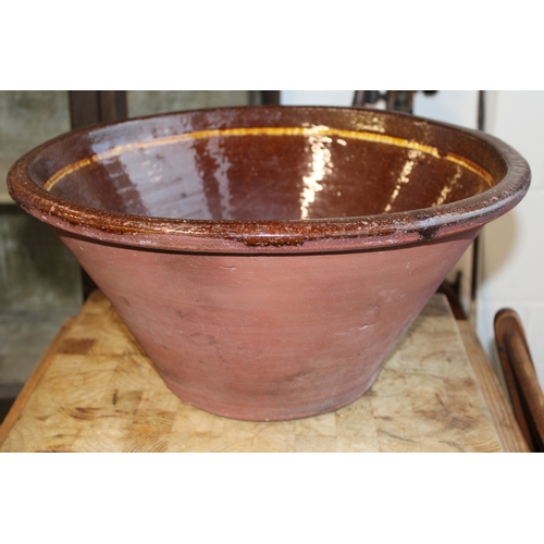 466 - An early 20th century farmhouse dairy bowl, also known as a pancheon or tian bowl, terracotta with g... 