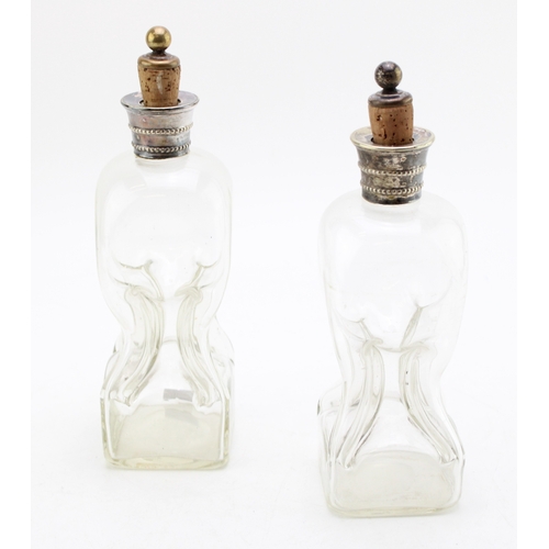 583 - Near pair of Victorian 'glug glug' decanters with silver plated collars, 23cm tall, (2).