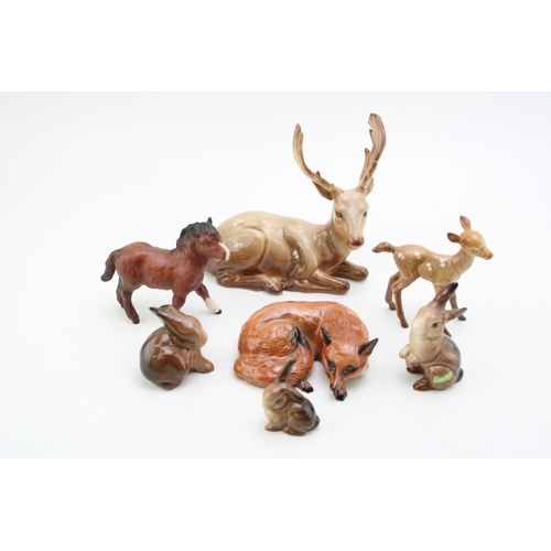 87 - Beswick to include three rabbits, a matt brown Shetland foal, an early painted curled fox 1017, a de... 