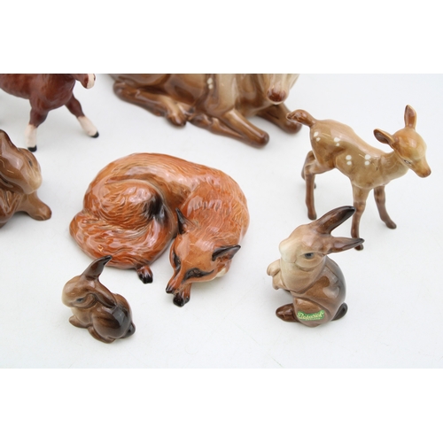87 - Beswick to include three rabbits, a matt brown Shetland foal, an early painted curled fox 1017, a de... 