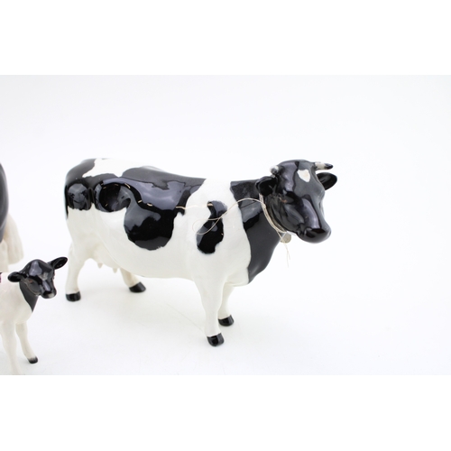 90 - Beswick Friesian cattle family to include the cow, the bull and the calf (3).
