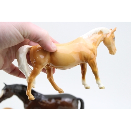 99 - Beswick to include a palomino boy's pony (restored), a lying 915 in grey, with other horses and foal... 