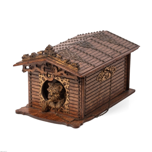 A late Victorian carved oak cigar humidor, with gilt bronze dog, in the form of a dog kennel, the lid rising to reveal a fitted interior for fifty-four cigars, the dog's chain forming the key chain, 32cm x 20cm x 18cm tall.
