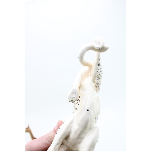 258 - A Beswick leopard with a baby giraffe (2).