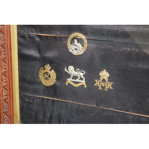16 - A Framed Collection of British Army Cap Badges Including a Victorian North Staffordshire 1st Volunte... 
