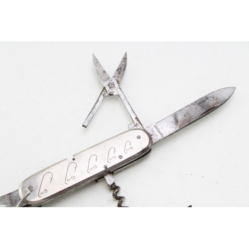 244 - An anglers / fisherman's multitool pocket knife with hook sizes engraved on scales, with measure in ... 