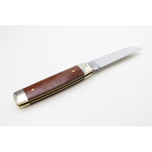 256 - A senator pocket knife with chased workback spring, by A Wright and Son of Sheffield, with wooden ha... 