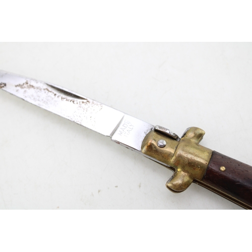 323 - A mid 20th century folding lock knife, made in Italy, in the form of a dagger, blade 7.5cm long, tot... 