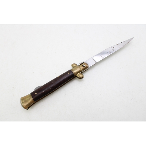 323 - A mid 20th century folding lock knife, made in Italy, in the form of a dagger, blade 7.5cm long, tot... 