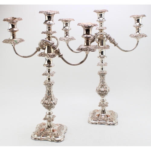 A pair of Sheffield plate or similar three-sconce candelabras with scrolling acanthus leaf decoration, weighted base,, 48.5cm tall (2).