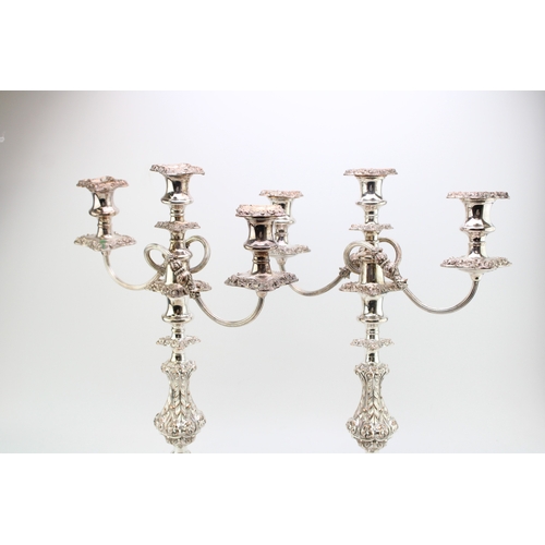 573 - A pair of Sheffield plate or similar three-sconce candelabras with scrolling acanthus leaf decoratio... 