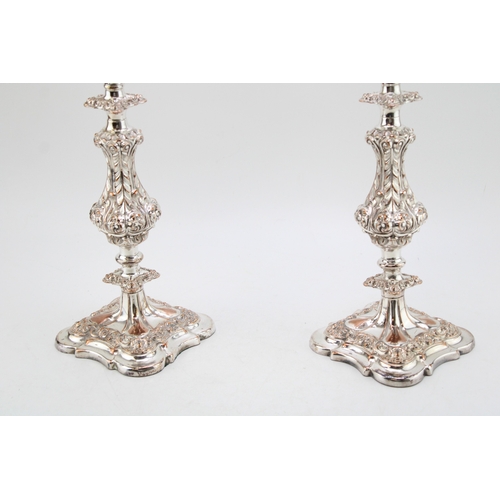 573 - A pair of Sheffield plate or similar three-sconce candelabras with scrolling acanthus leaf decoratio... 