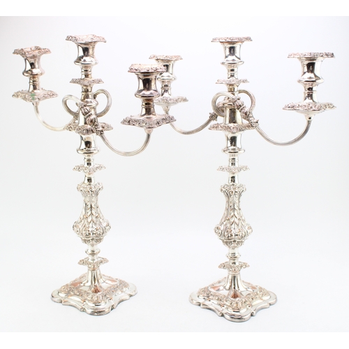 573 - A pair of Sheffield plate or similar three-sconce candelabras with scrolling acanthus leaf decoratio... 