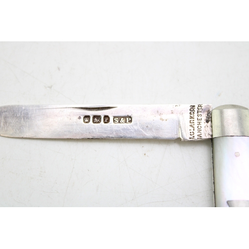 10 - A silver and mother of pearl travelling multi-tool pocket knife eating set, campaign style, split in... 