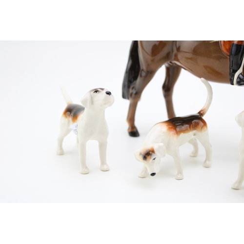 22 - Beswick Huntsman on brown horse together with four hounds, 21.5cm tall, (5).