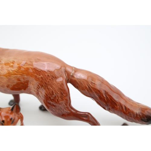 29 - A group of Beswick foxes to include large stalking fox (tail af), curled fox 1017, together with thr... 