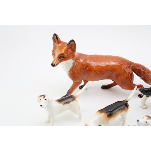 36 - Beswick to include a large standing fox, a large collie, 3 fox hounds, a small standing fox and a sm... 