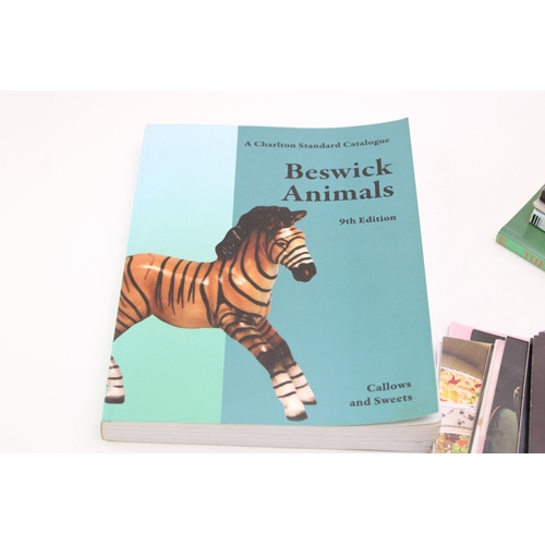42 - An interesting collection of Beswick books and ephemera to include a 9th Edition Charlton price guid... 