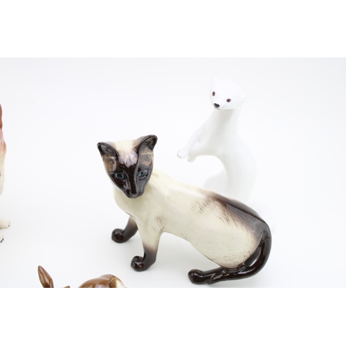 45 - Two Beswick Siamese cats, 1558 and one other, with a large stoat, probably USSR, a seated model of a... 