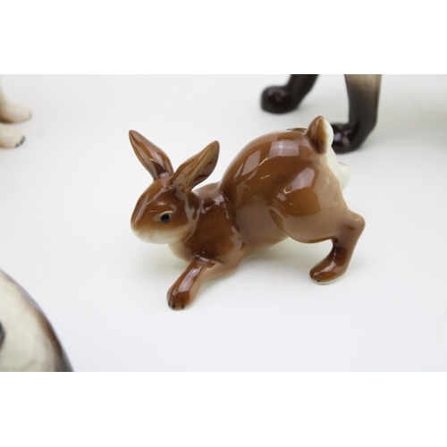 45 - Two Beswick Siamese cats, 1558 and one other, with a large stoat, probably USSR, a seated model of a... 